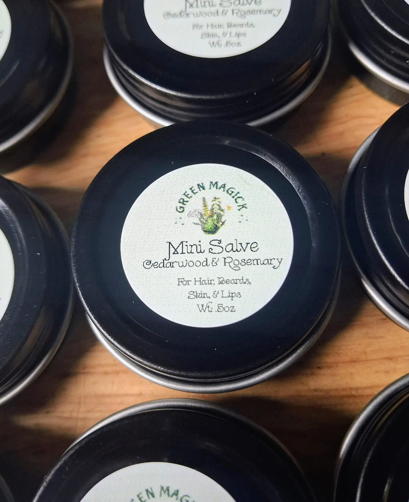Tins of Green Magick mini salve with cedarwood and rosemary