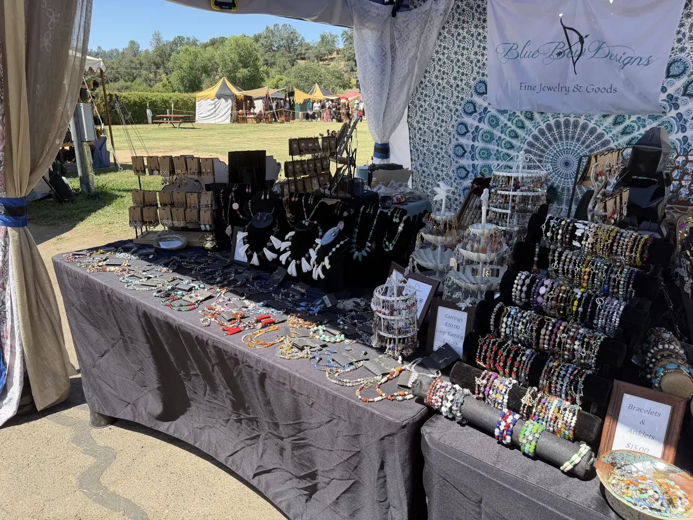Rows of bracelets and necklaces on display racks at a jewelry stall